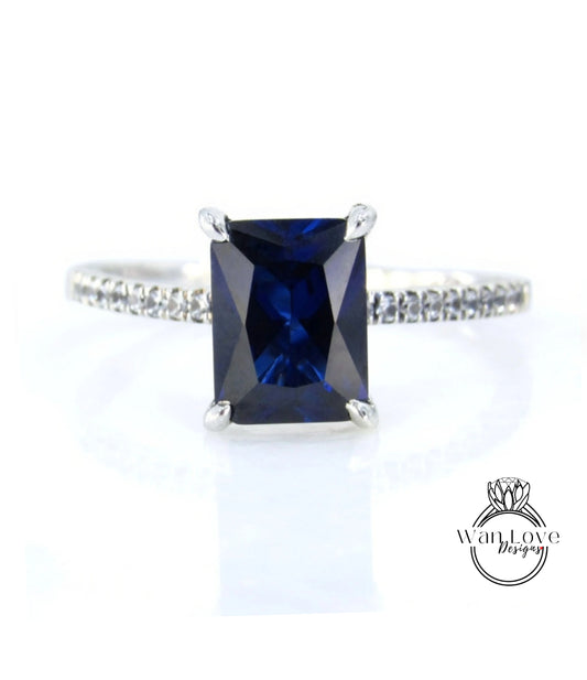 A ring with a large blue gemstone, likely a sapphire, set in a silver band.