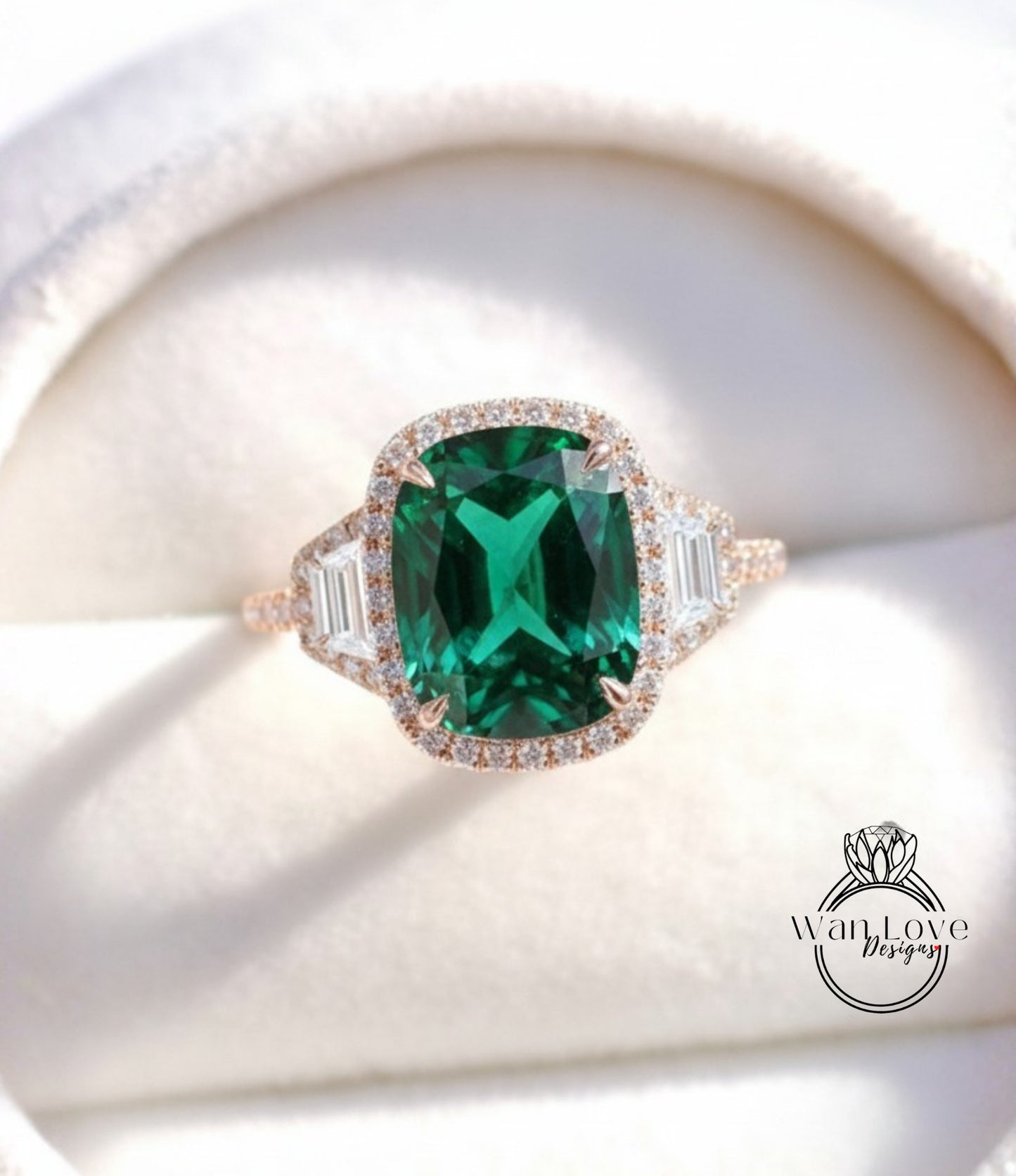 A stunning engagement ring with a large, vibrant green gemstone set in a halo of smaller diamonds, surrounded by a delicate gold band.