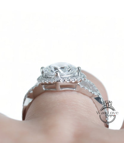 A close-up view of a diamond engagement ring on a person's hand, showcasing the intricate details and sparkling gemstone.