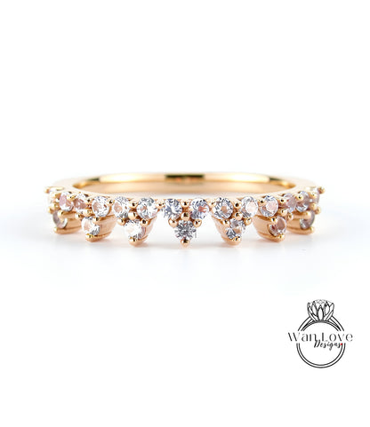 A gold ring with a row of small diamonds set in the center, showcasing the intricate design and craftsmanship of the piece.