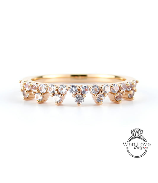 A gold ring with a row of small diamonds set in the center, showcasing the intricate design and craftsmanship of the piece.