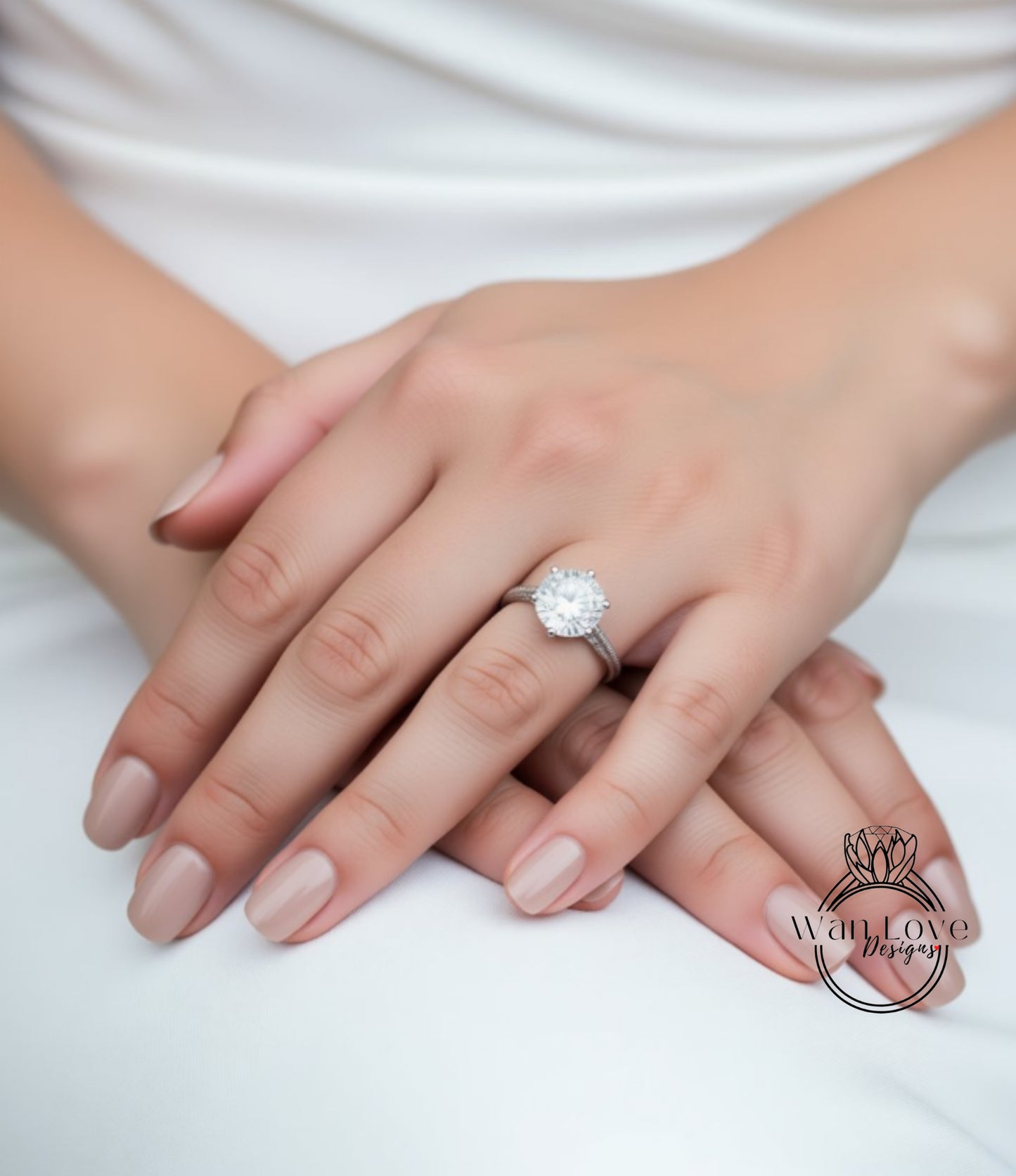 A close-up of a person's hands wearing a large diamond engagement ring.