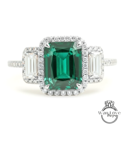 A stunning engagement ring with a large, vibrant green gemstone surrounded by smaller diamonds.