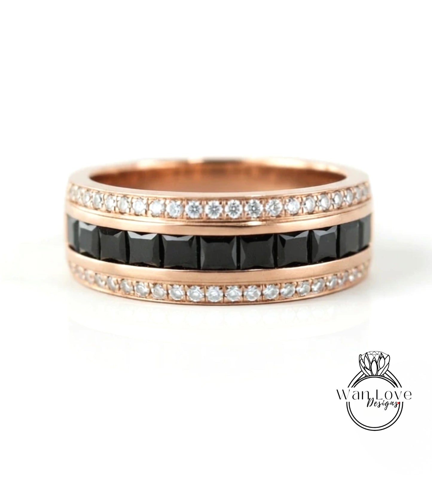 A rose gold ring with a band of black diamonds and a band of white diamonds.