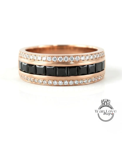 A rose gold ring with a band of black diamonds and a band of white diamonds.