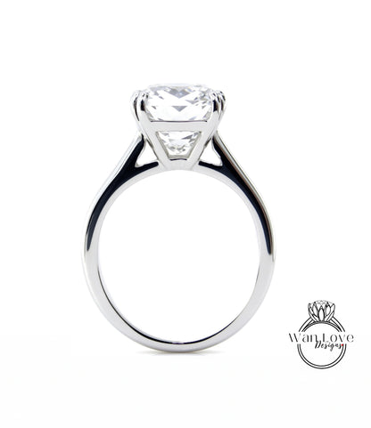 A large, elegant diamond engagement ring with a prominent center stone.
