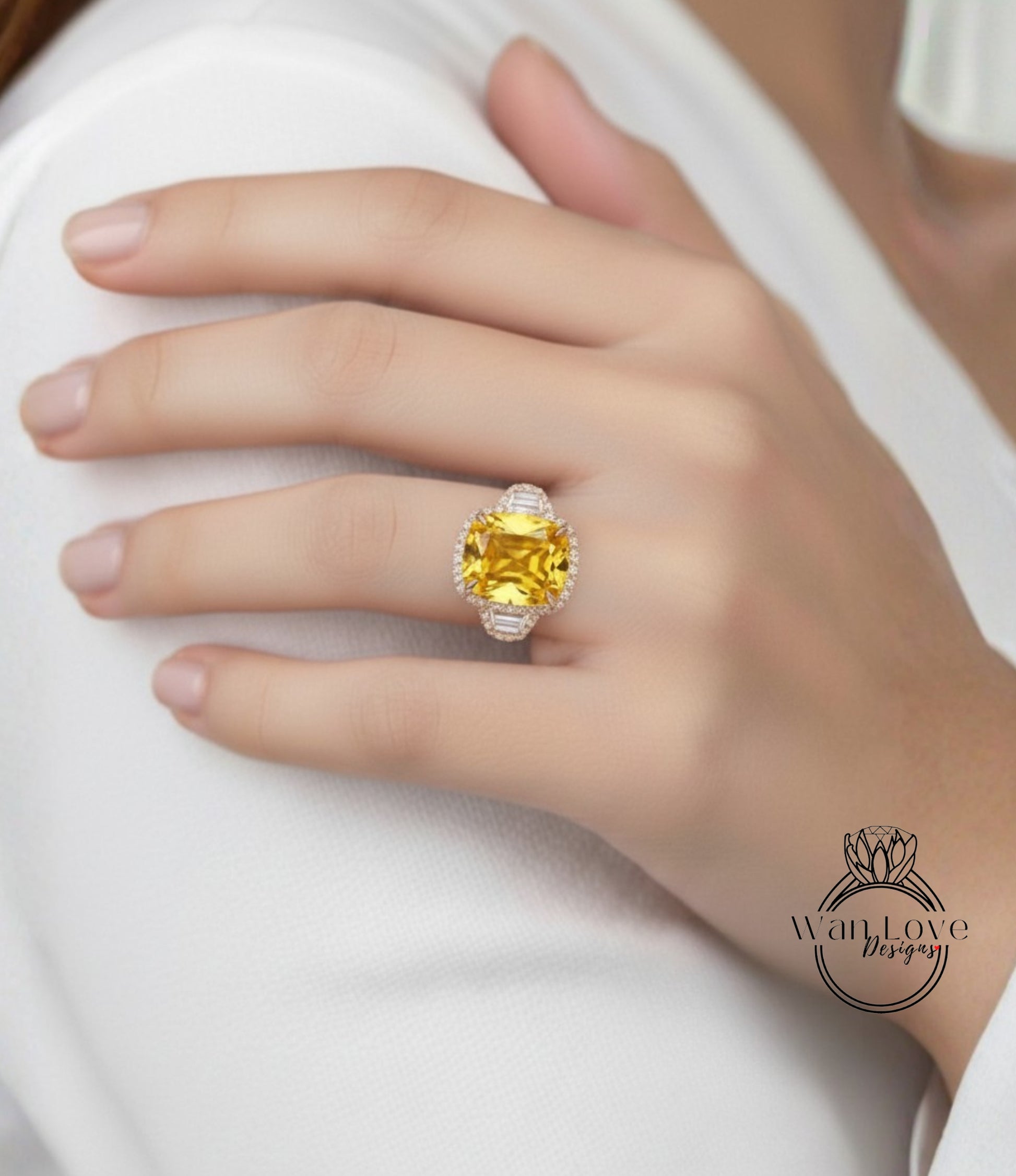 A close-up of a person's hand wearing a large, yellow gemstone ring on the ring finger.