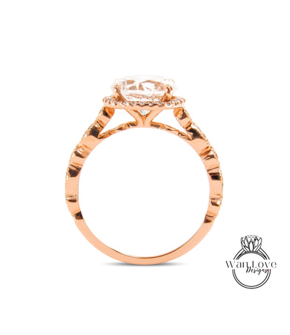 A rose gold engagement ring with a large central diamond and a halo of smaller diamonds around the center stone.
