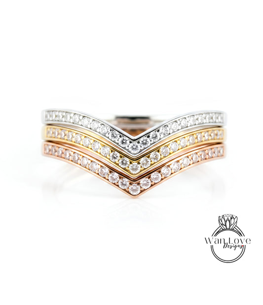 A close-up image of a ring with three layers of diamond-encrusted bands, showcasing the intricate design and craftsmanship of the jewelry piece.