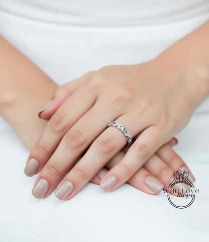 A close-up image of a person's hands wearing a ring with a floral design.