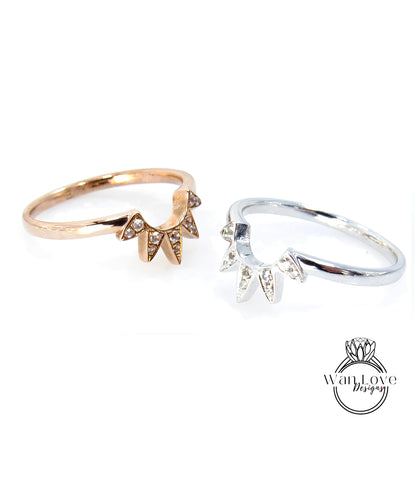 two rings, one with a gold band and the other with a silver band, both featuring a unique design with spikes or spikes on the band.