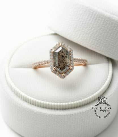 A diamond engagement ring is displayed in a white jewelry box, showcasing the ring's intricate design and sparkling gemstones.