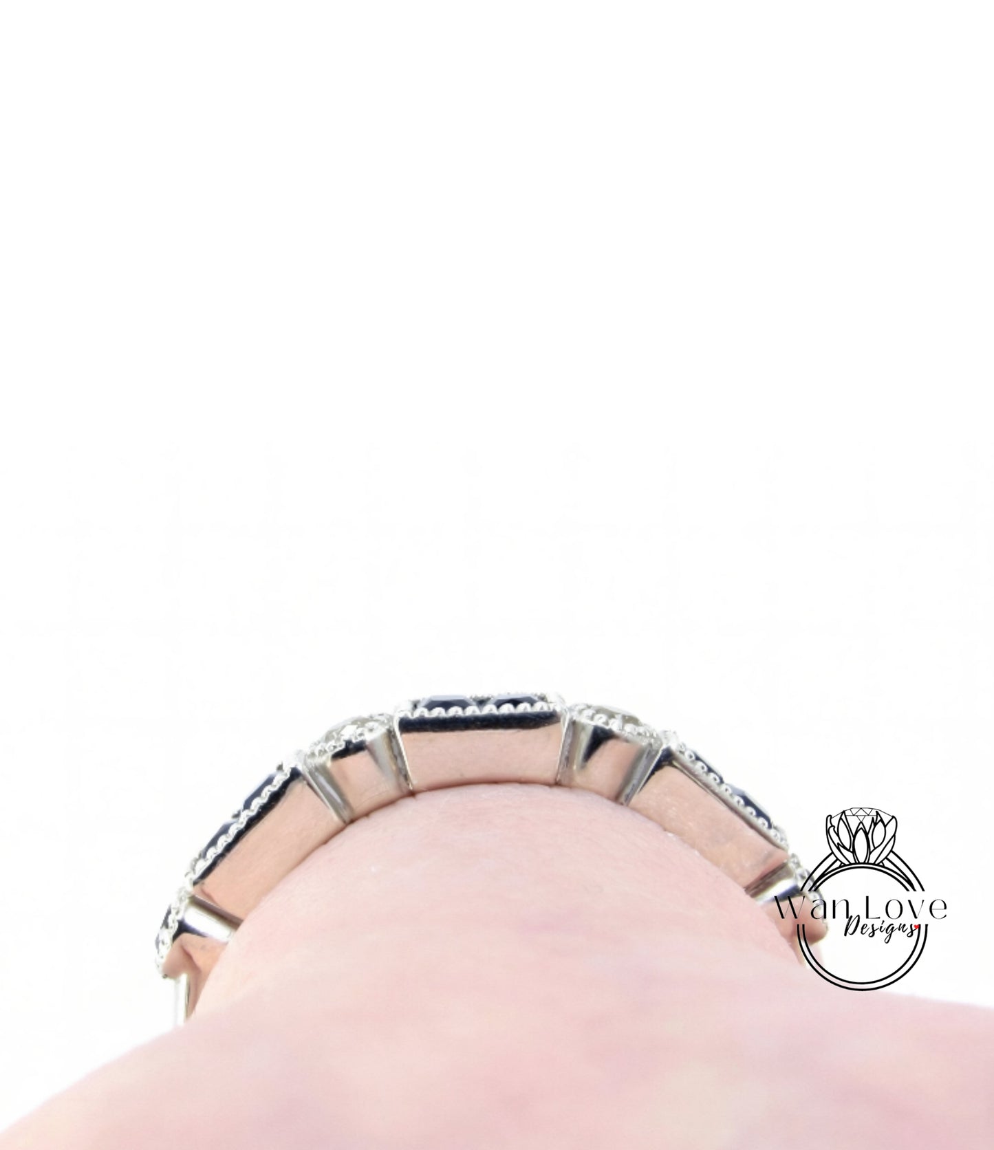A close-up view of a silver bracelet with a row of small diamonds on it, worn on a person's wrist.