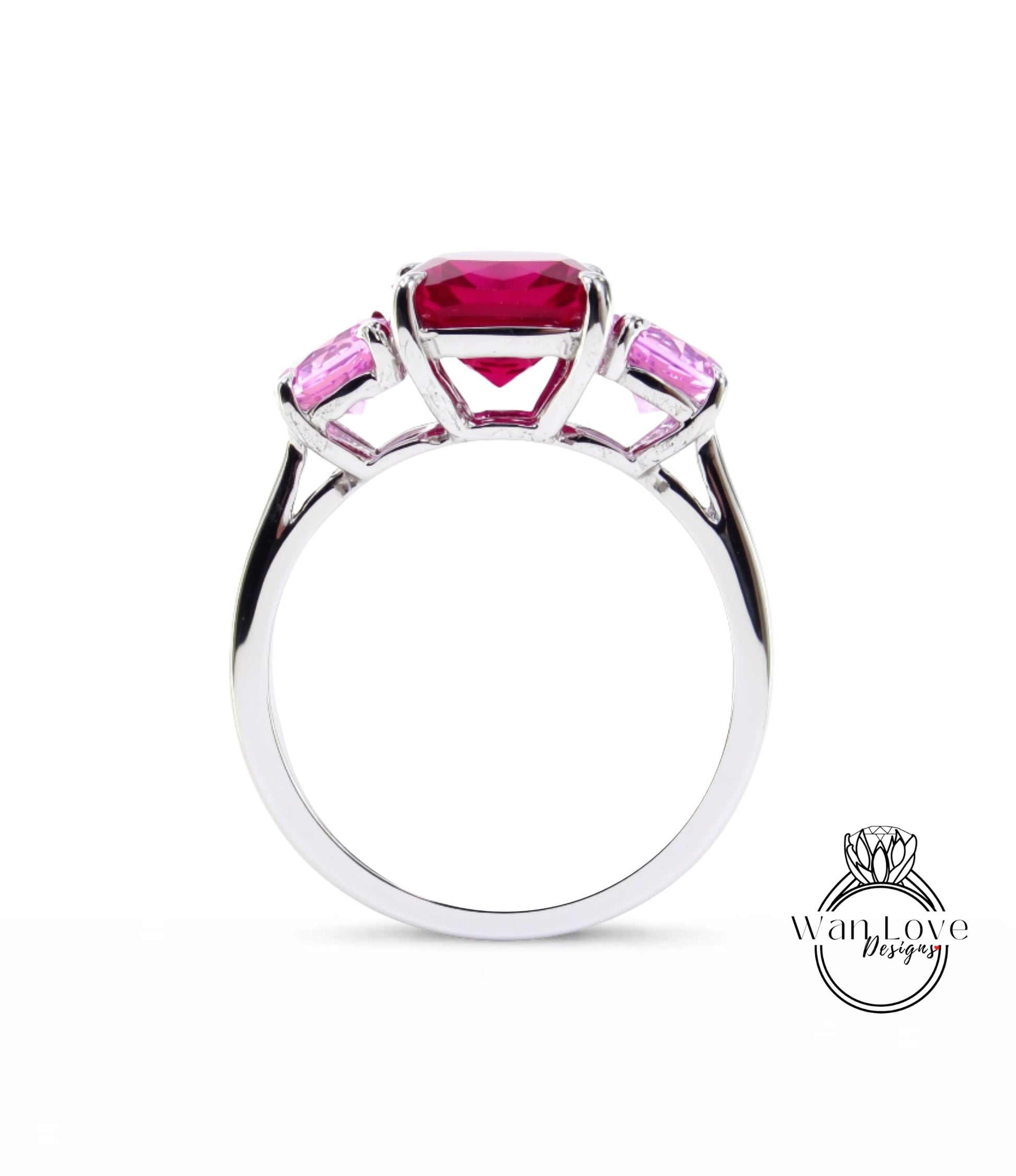 A silver ring with a large pink gemstone in the center, surrounded by smaller pink gemstones.