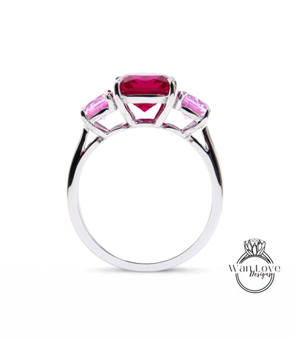 A silver ring with a large pink gemstone in the center, surrounded by smaller pink gemstones.