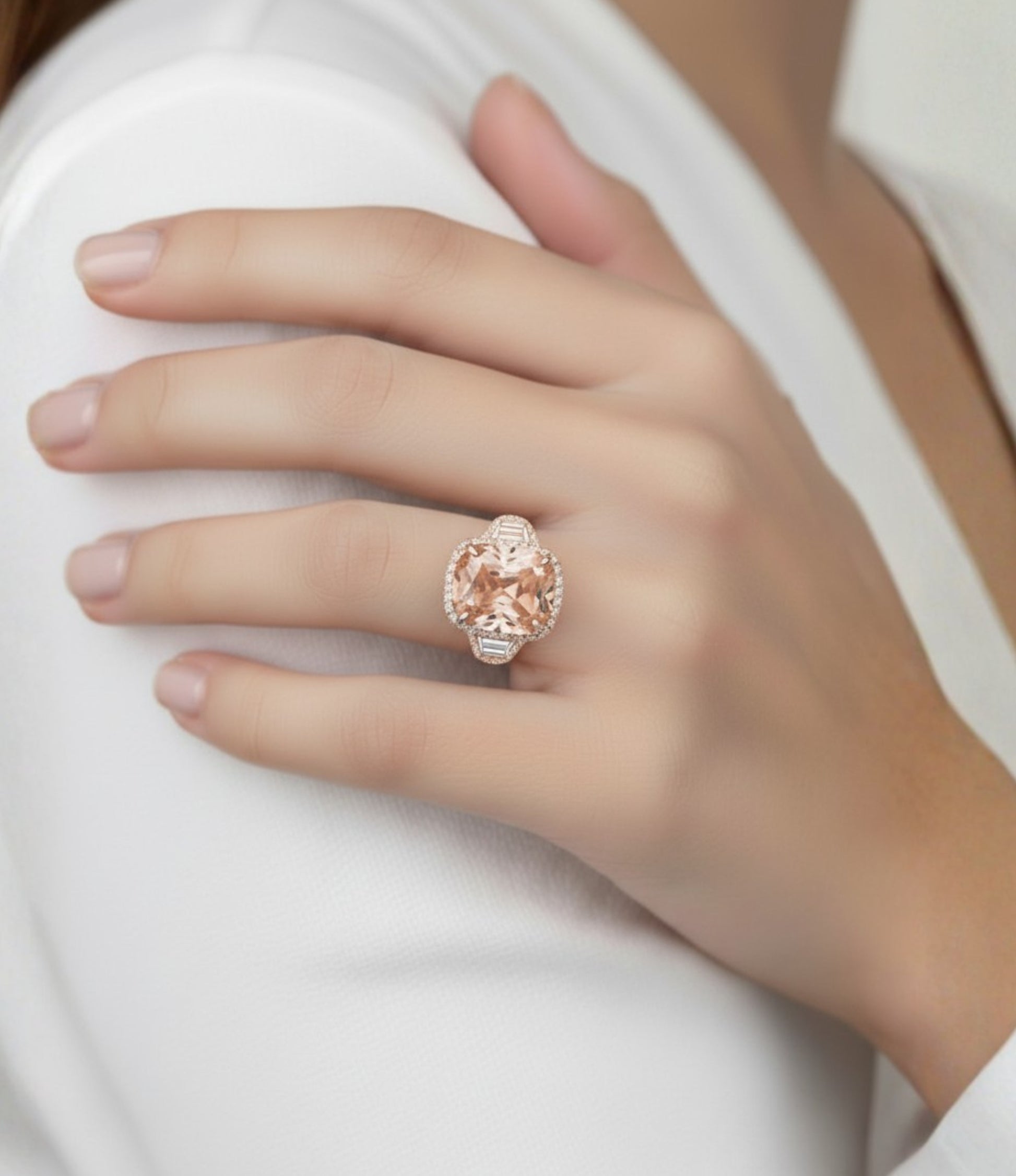 A close-up of a person's hand wearing a large, ornate ring with a large, round, pink gemstone.