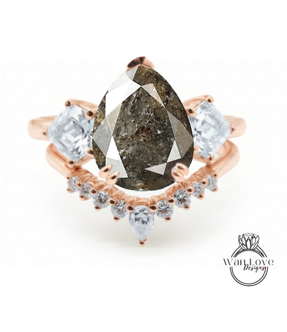 a ring with a large pear-shaped diamond as the centerpiece, surrounded by smaller diamonds and a rose gold band.