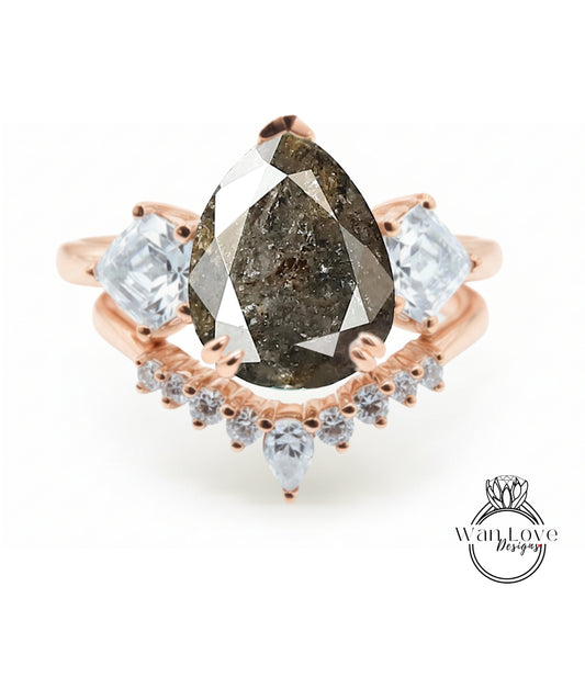 a ring with a large pear-shaped diamond as the centerpiece, surrounded by smaller diamonds and a rose gold band.