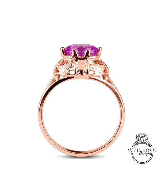 A rose gold ring with a large purple gemstone set in the center.