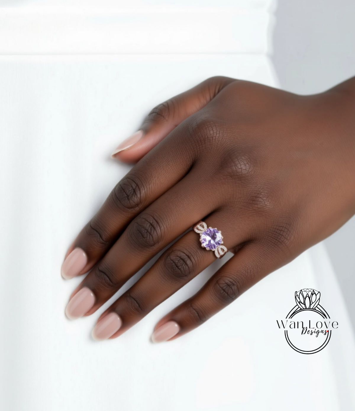 A close-up of a hand wearing a ring with a purple gemstone.