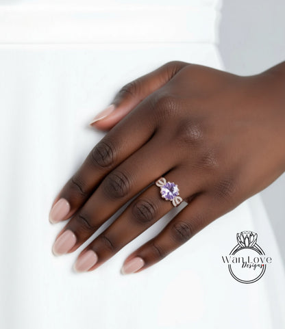 A close-up of a hand wearing a ring with a purple gemstone.
