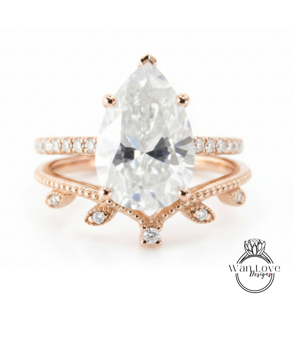A close-up image of a beautiful engagement ring featuring a large pear-shaped diamond set in a rose gold band with a leaf-shaped accent.