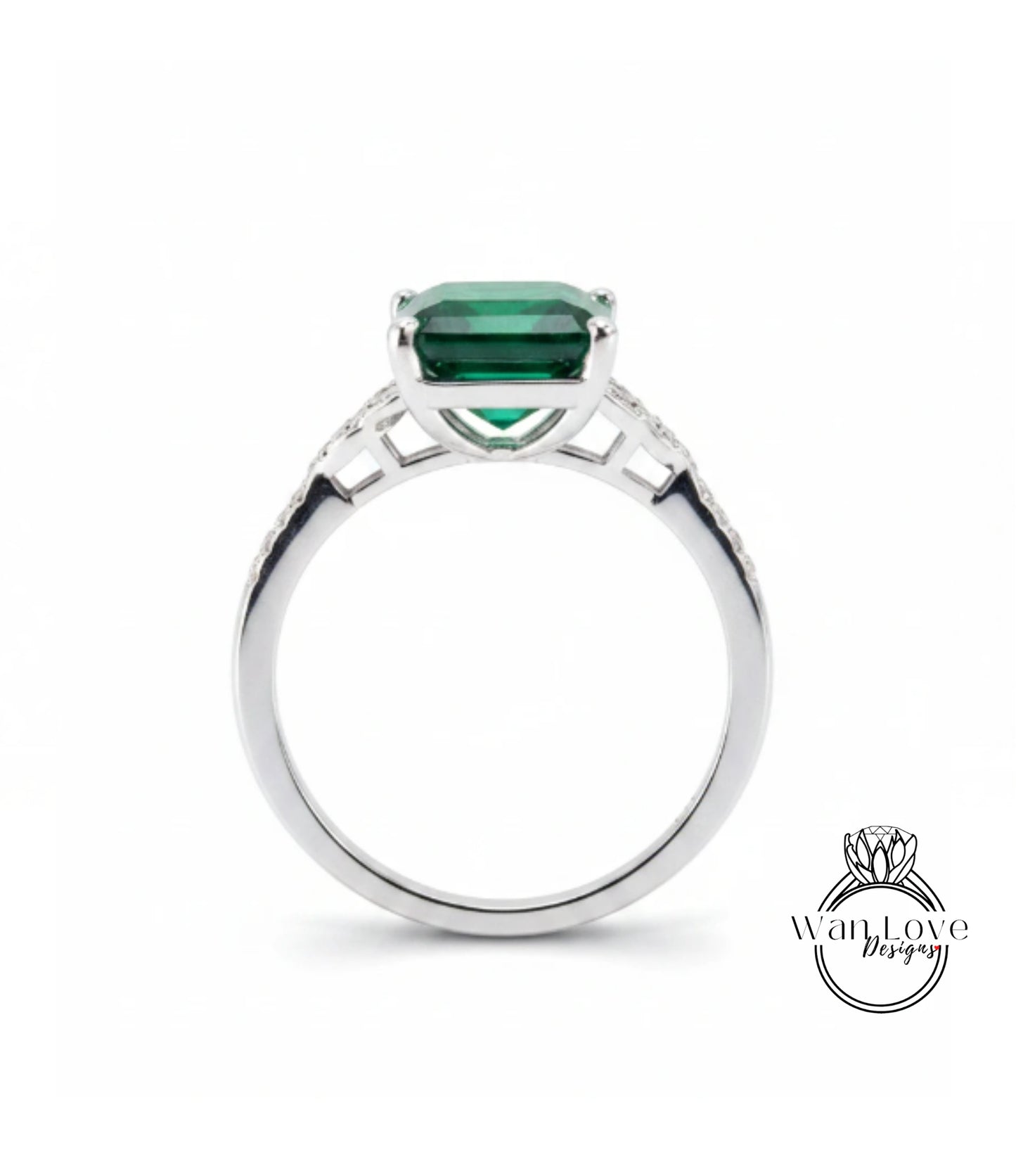 A silver ring with a large, green gemstone set in the center.