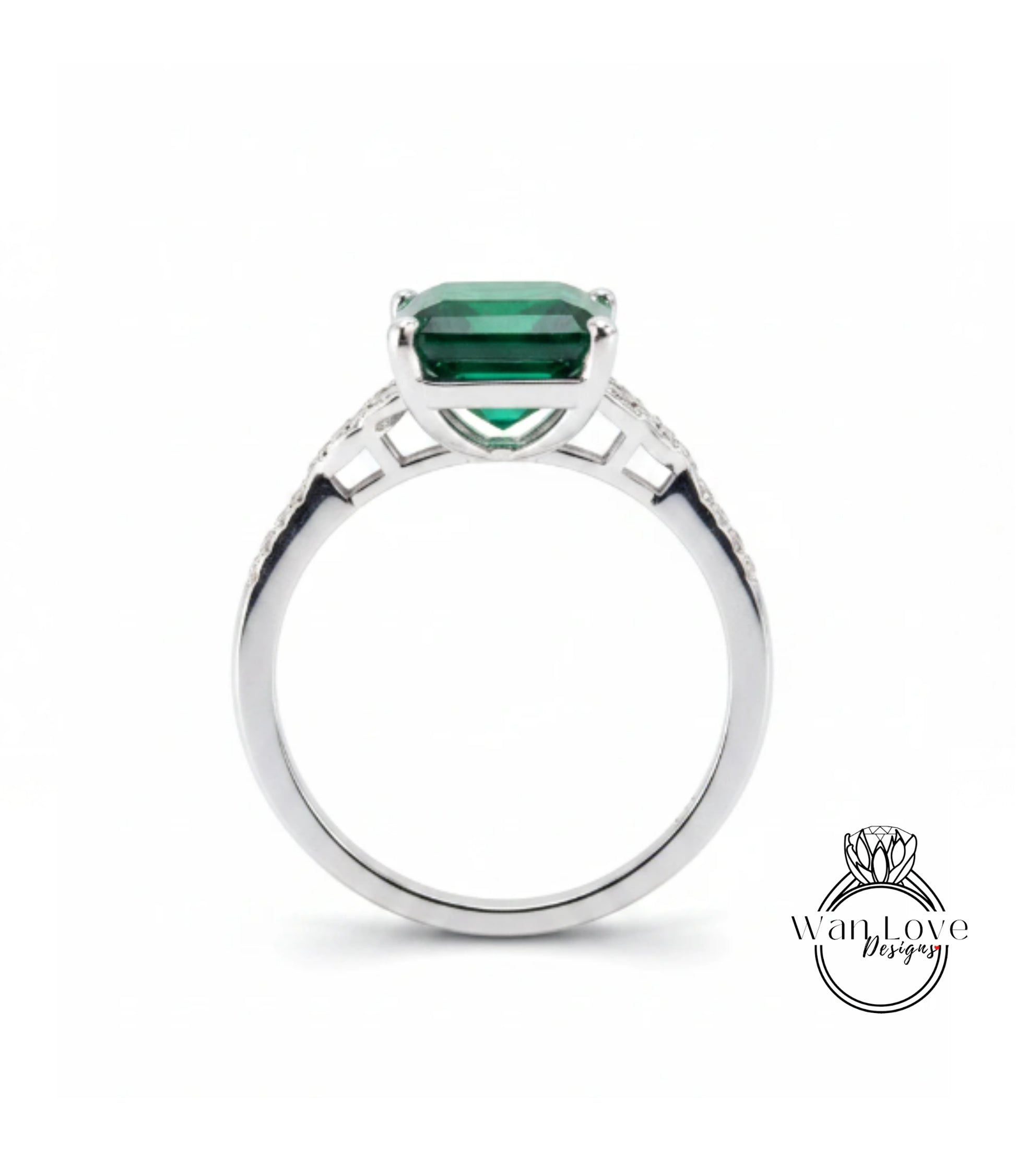 A silver ring with a large, green gemstone set in the center.