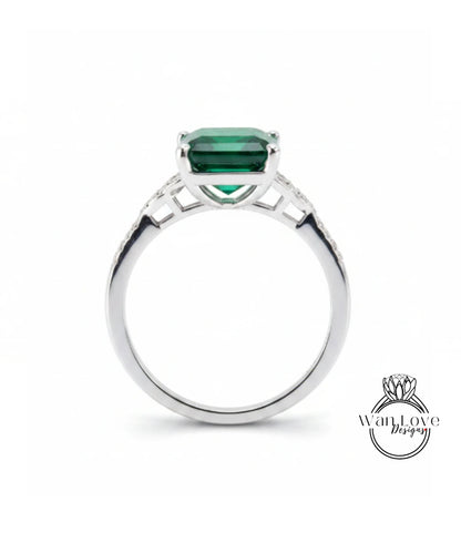 A silver ring with a large, green gemstone set in the center.