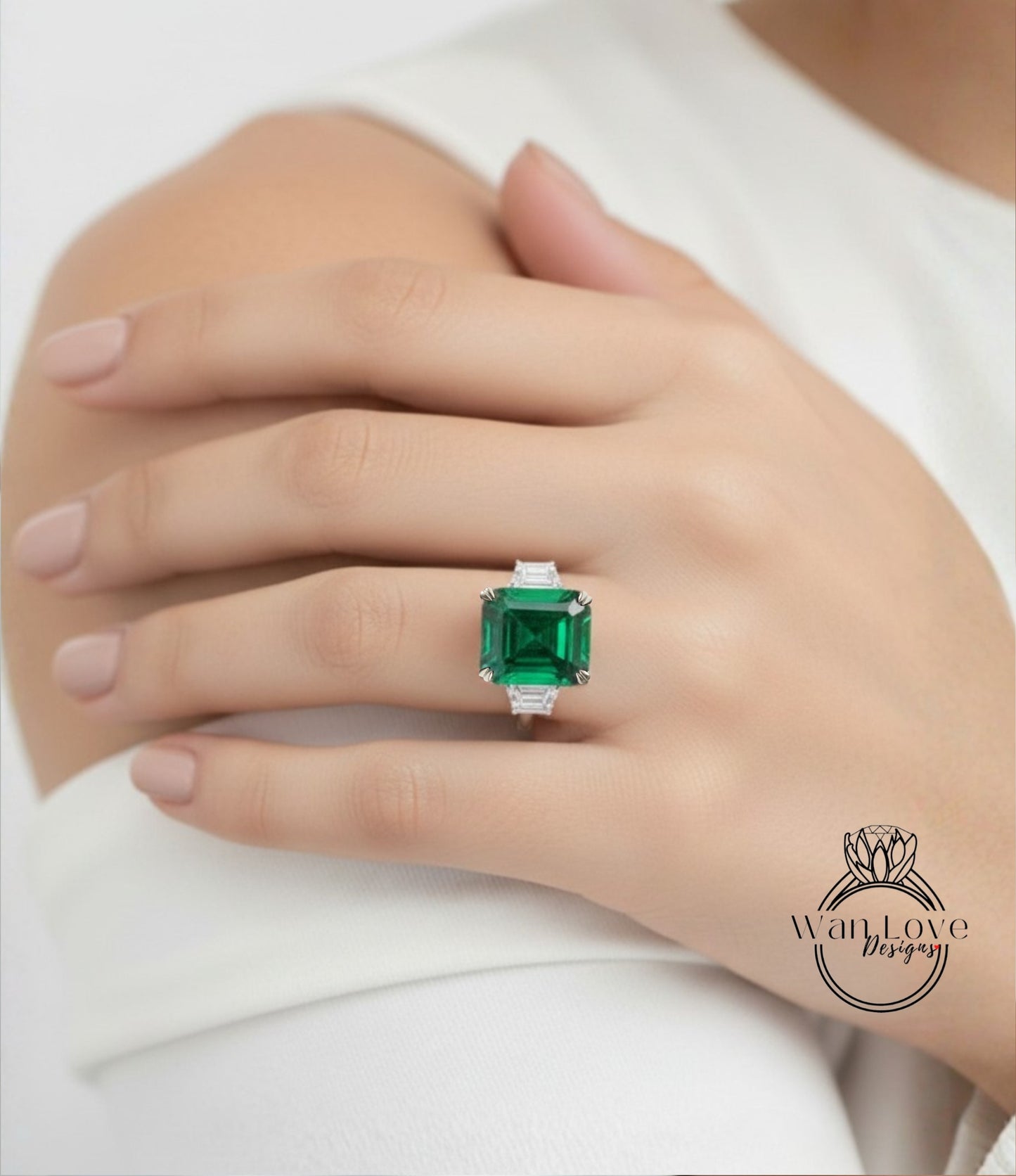 A close-up of a person's hand wearing a large, green gemstone ring.