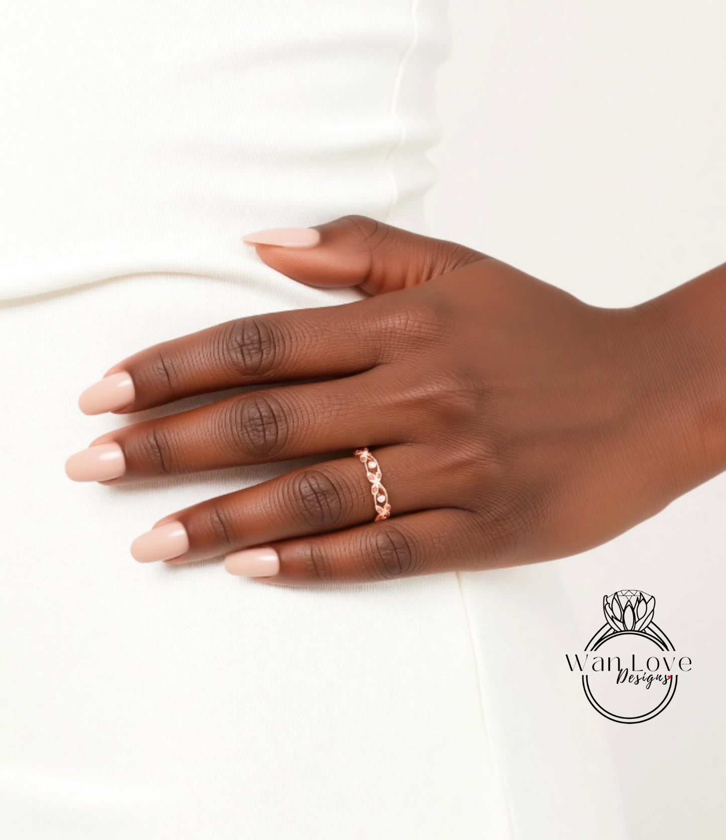A close-up of a hand wearing a gold ring on the ring finger.