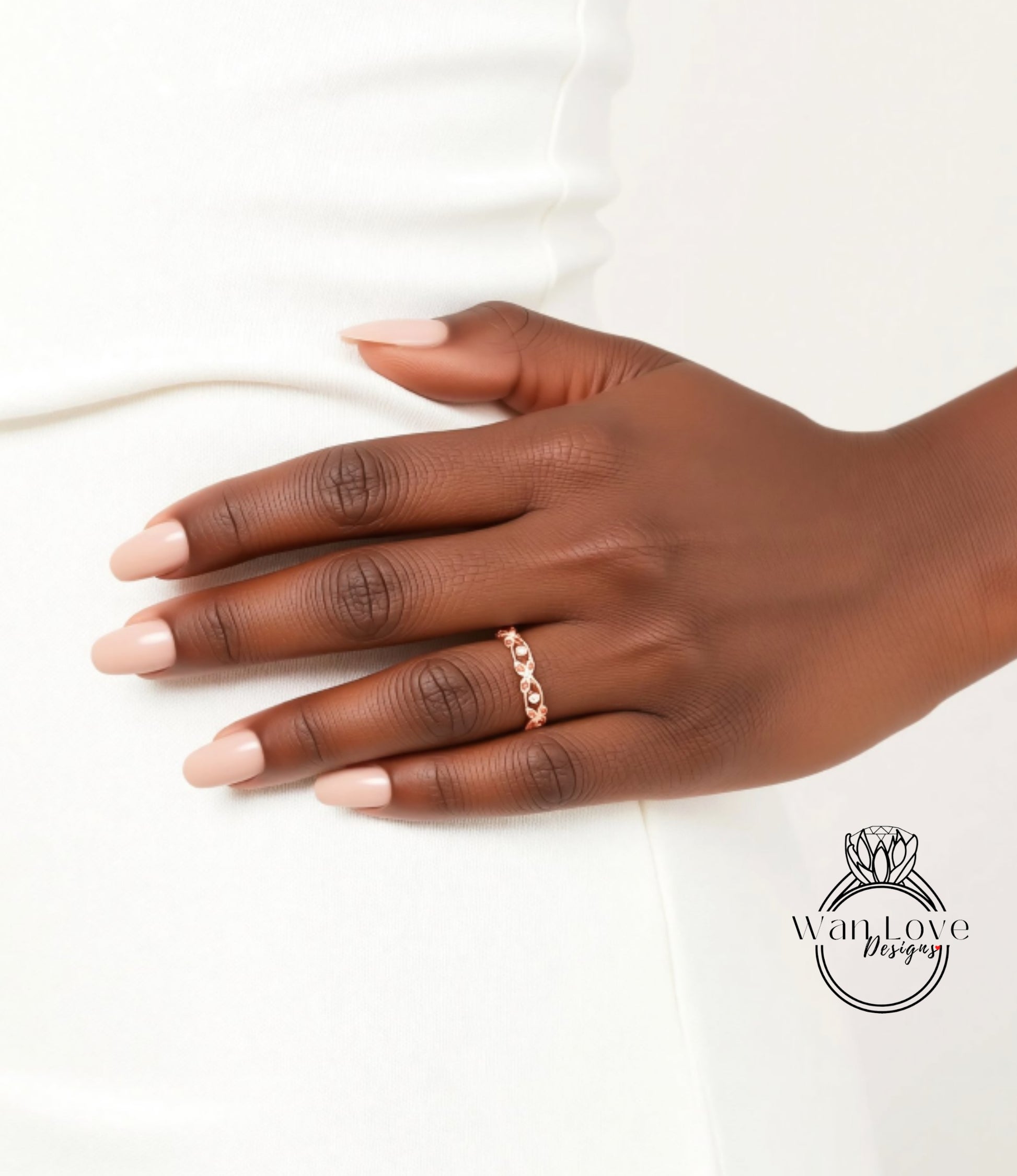 A close-up of a hand wearing a gold ring on the ring finger.