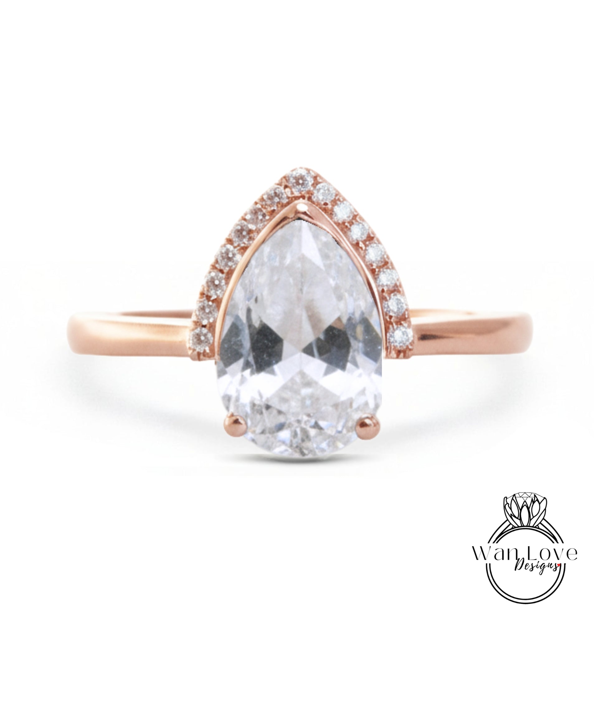 A rose gold ring with a large, clear pear-shaped gemstone set in the center, surrounded by smaller diamonds.