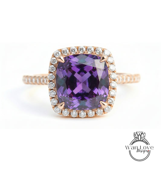 a beautiful ring with a large purple gemstone set in a halo of smaller diamonds.