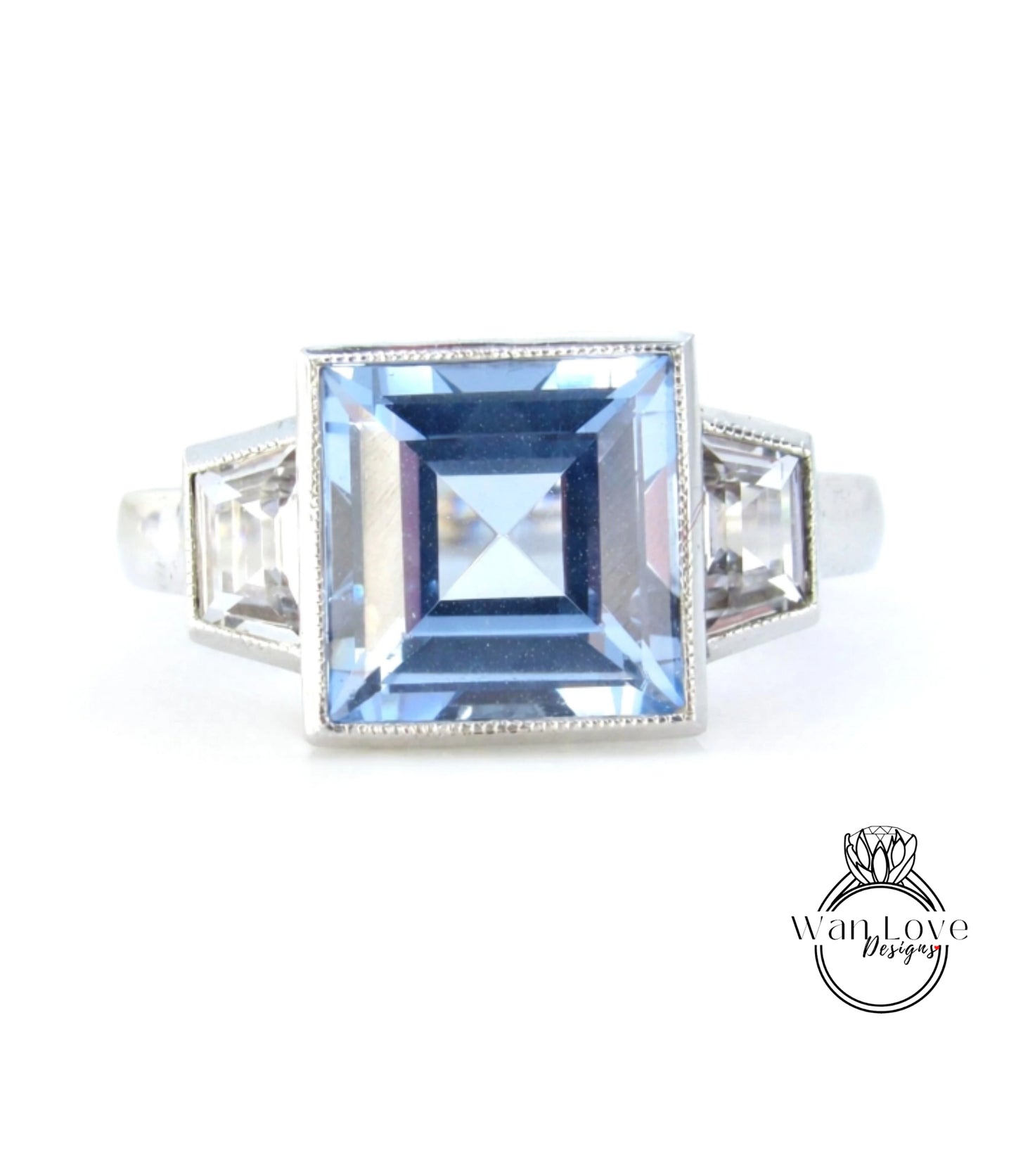A silver ring with a large blue gemstone in the center.