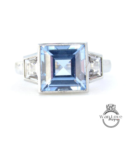 A silver ring with a large blue gemstone in the center.