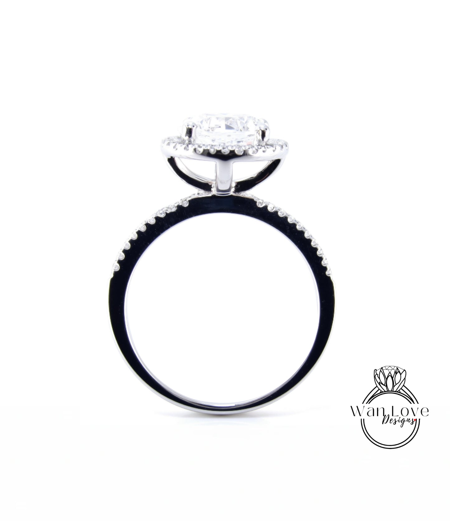 A silver engagement ring with a large central diamond surrounded by smaller diamonds, set in a halo of smaller diamonds.