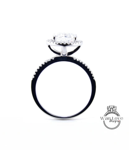 A silver engagement ring with a large central diamond surrounded by smaller diamonds, set in a halo of smaller diamonds.