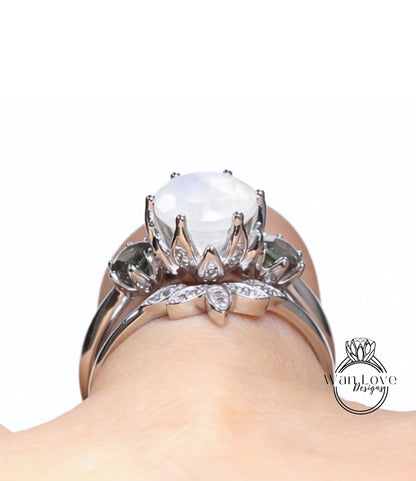 A close-up view of a silver ring with a large white gemstone, featuring a floral design and smaller gemstones.
