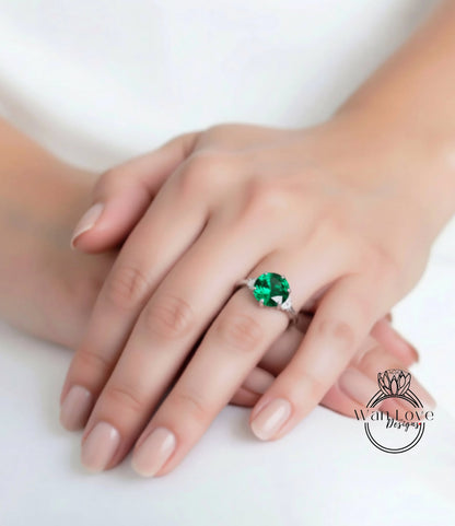 A close-up of a person's hand wearing a large, green gemstone ring.