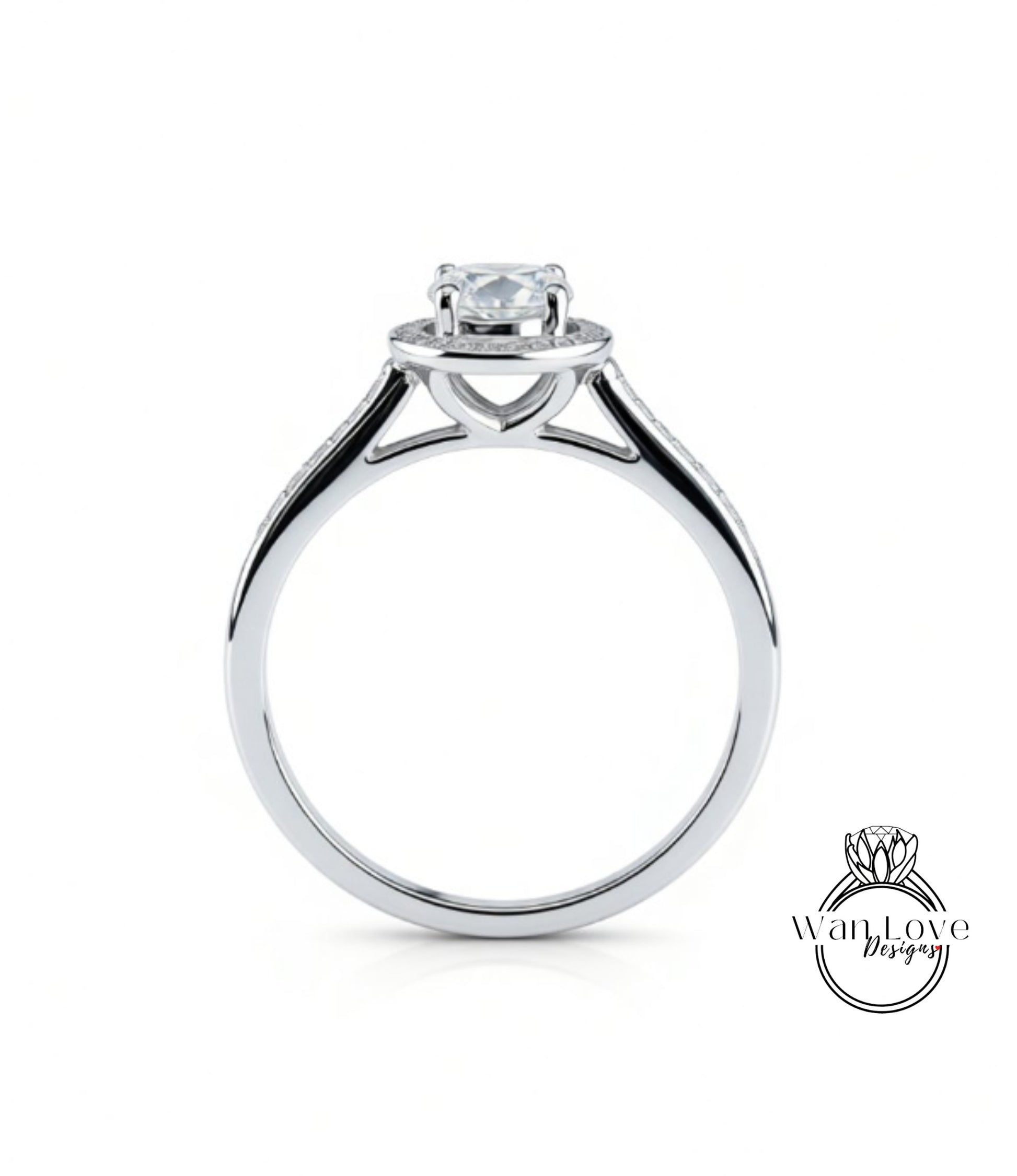 A silver engagement ring with a large central diamond and a halo of smaller diamonds around the center stone.