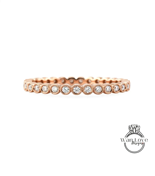 A rose gold ring with a row of small diamonds set in the center.