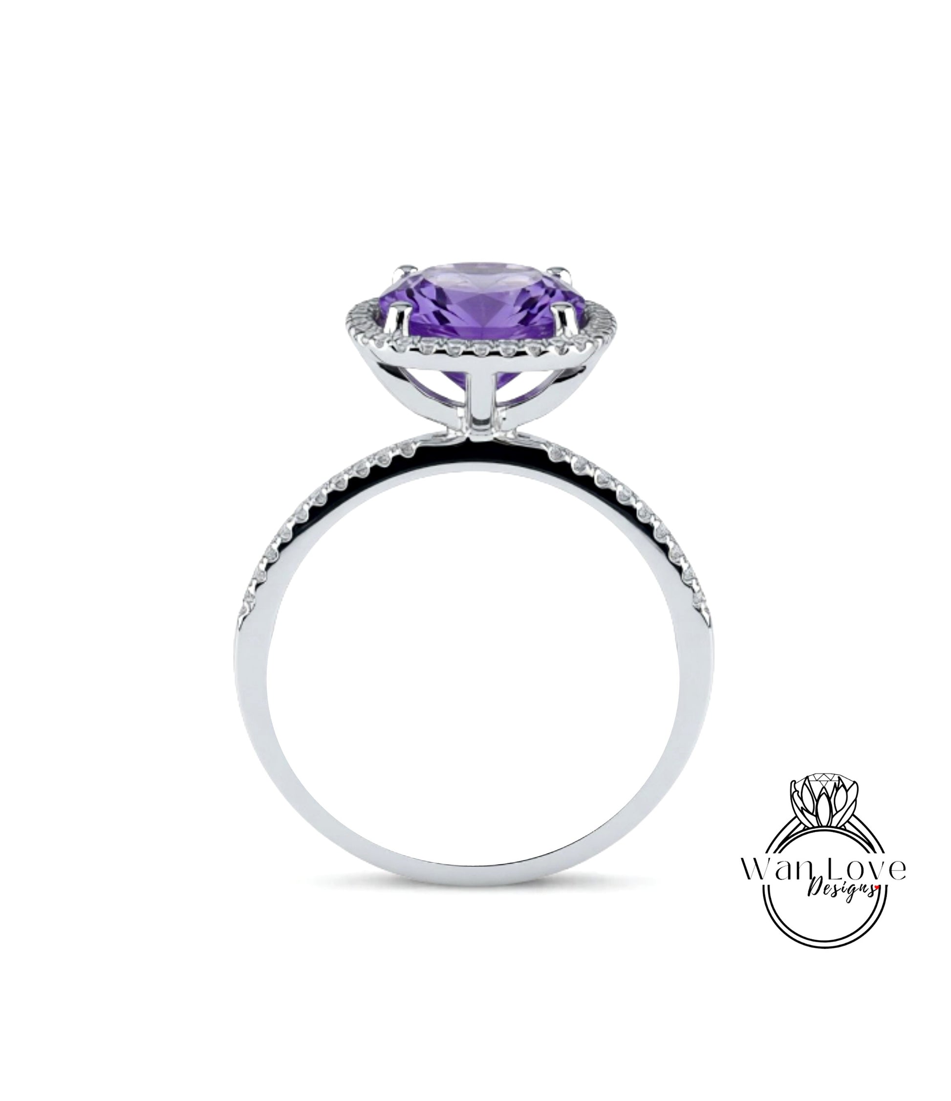 A silver ring with a large purple gemstone, likely an amethyst, set in a halo of smaller diamonds.