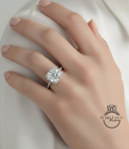 A close-up of a hand wearing a large diamond engagement ring.