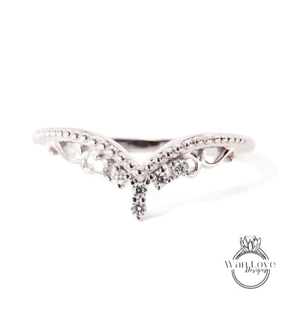 A silver ring with a decorative design featuring a central diamond and smaller diamonds surrounding it.