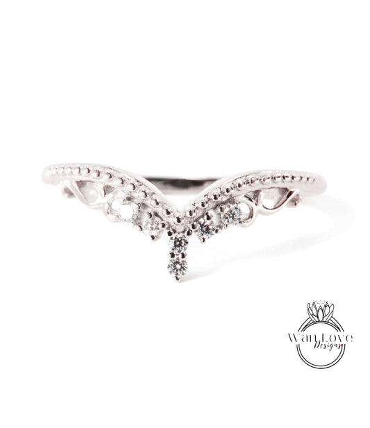 A silver ring with a decorative design featuring a central diamond and smaller diamonds surrounding it.