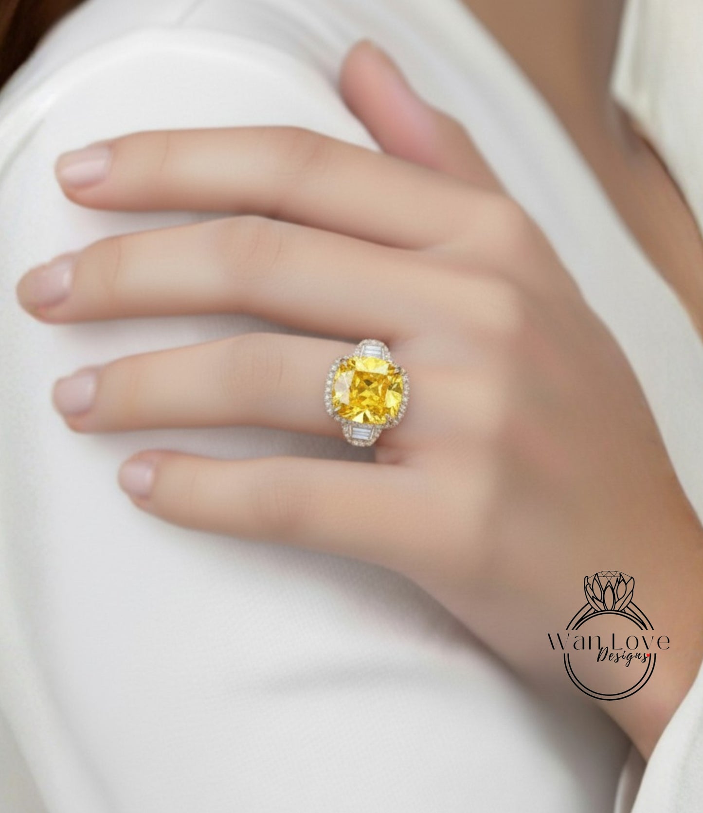 A close-up of a person's hand wearing a large yellow diamond ring on the ring finger.