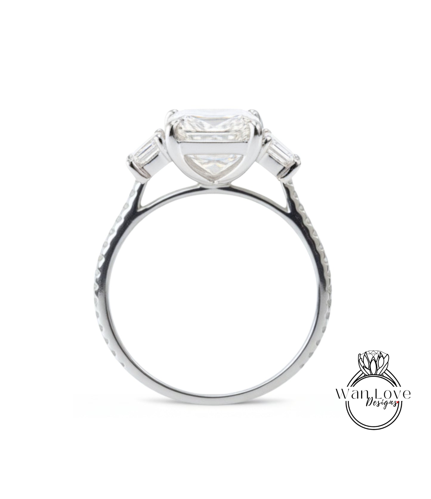 A silver engagement ring with a large, clear gemstone set in the center, surrounded by smaller stones.