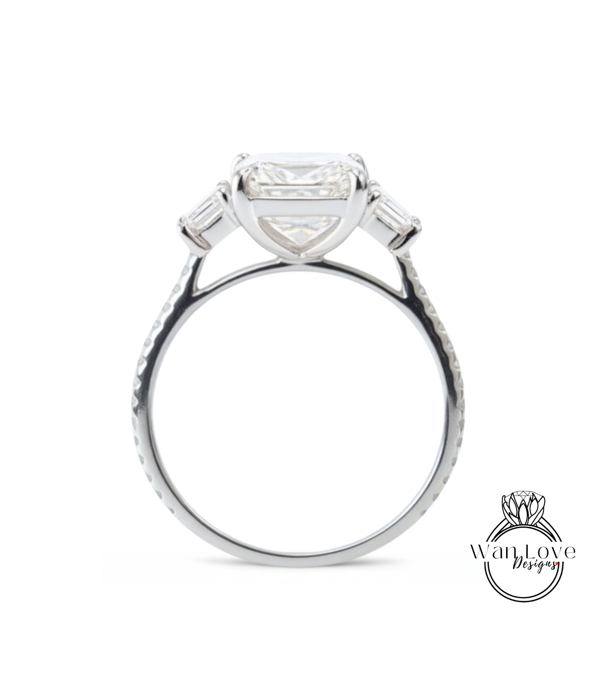 A silver engagement ring with a large, clear gemstone set in the center, surrounded by smaller stones.