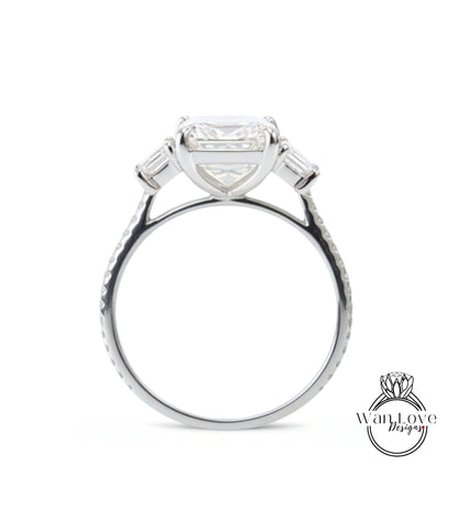 A silver engagement ring with a large, clear gemstone set in the center, surrounded by smaller stones.